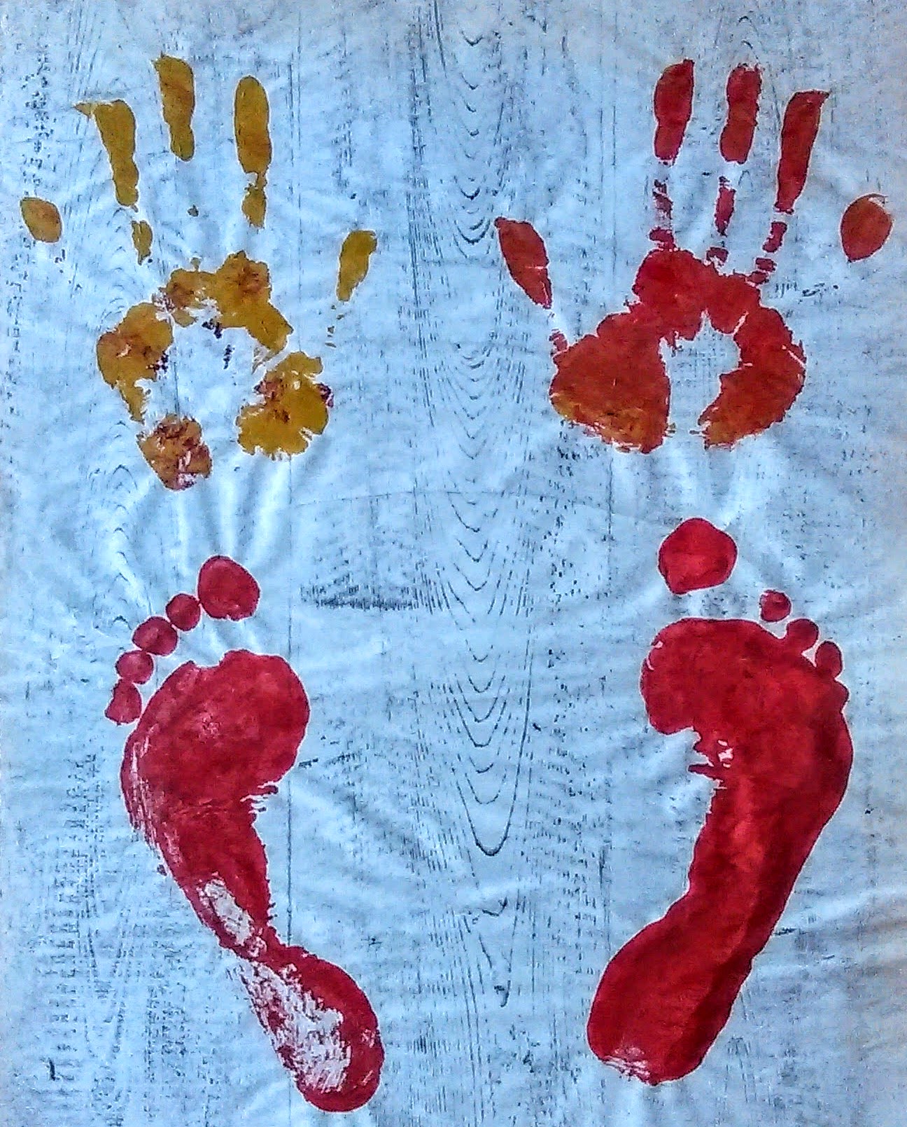 Painting of hand and foot prints over rubbing of grained timber boards